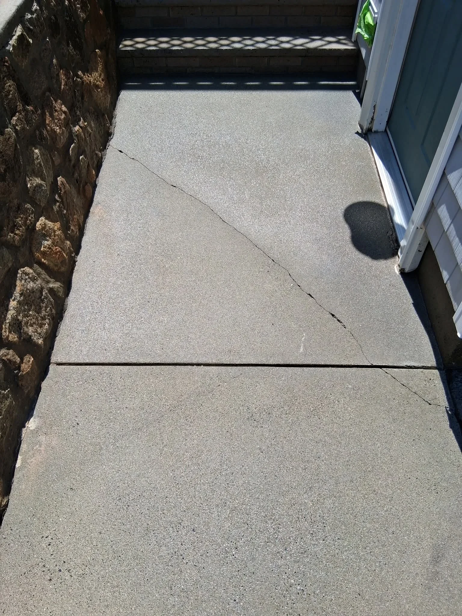 Clean concrete entryway with pressure-washed surface and visible joint lines
