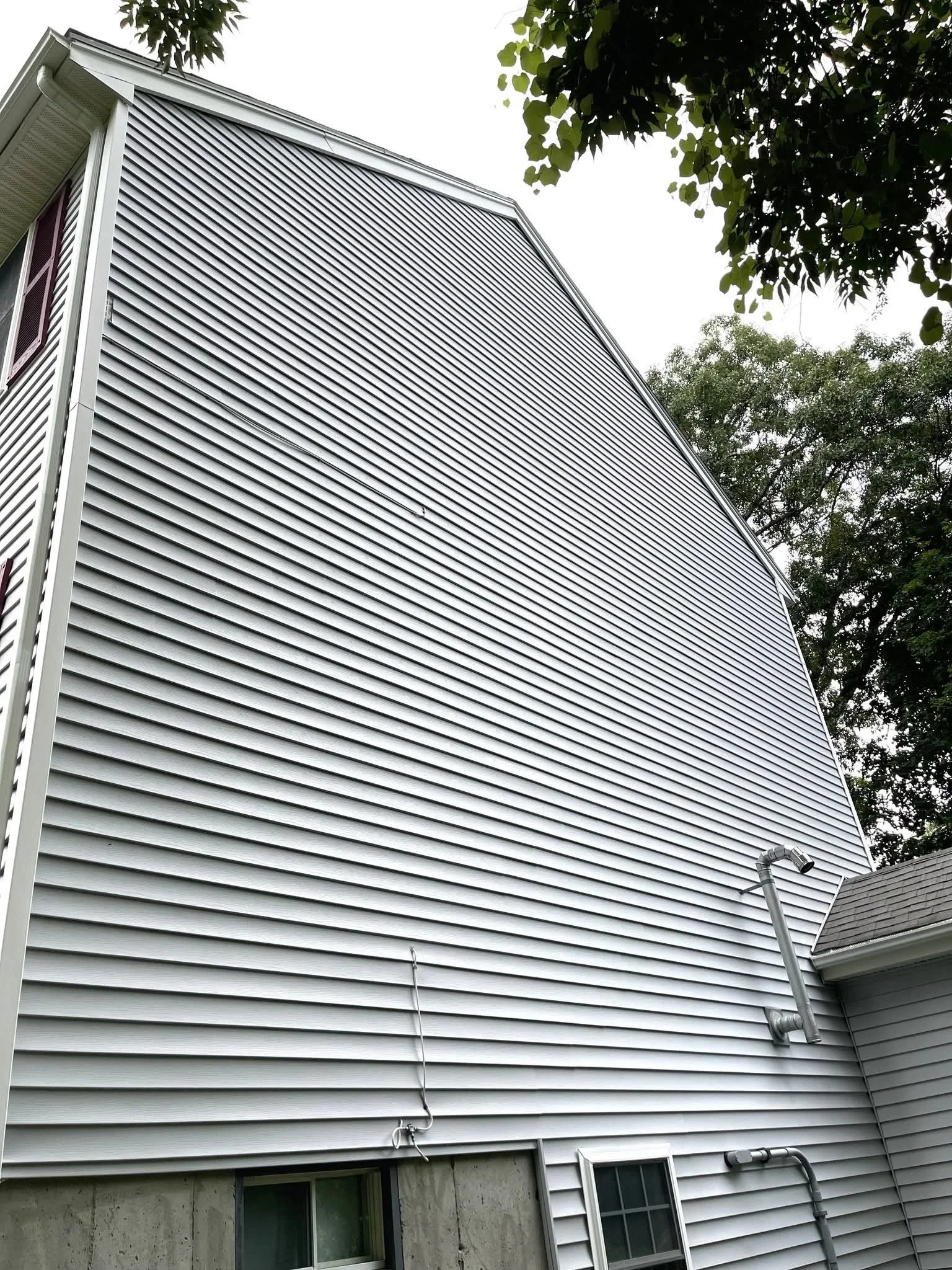 Clean horizontal vinyl siding on residential home exterior wall
